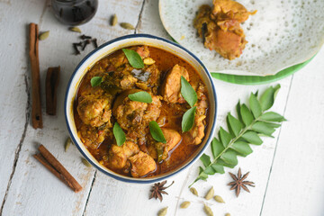 Masala Chicken curry with Appam Kerala breakfast , Hoppers pan cake , homemade chicken roast Indian spices , Asian cuisine spicy meat curry cooked in coconut milk . side dish Christian food Christmas