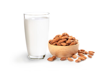 Glass of almond milk and almonds in wooden bowl isolated on white background.
