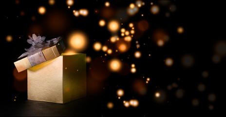 Christmas box expelling colored balls with black background