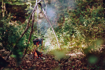 Blackened camping pots and a cauldron out of the fire. It's spring.