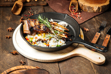 Mutton ribs with vegetables rice in cast iron pan