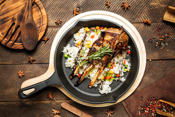 Mutton ribs with vegetables rice in cast iron pan