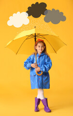 Cute little girl in raincoat and with umbrella under drawn cloudy sky on color background