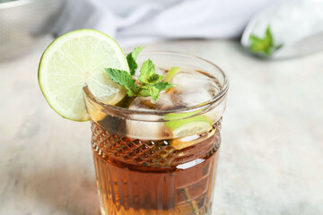 Glass of tasty Cuba Libre cocktail on table