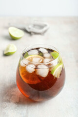 Glass of tasty Cuba Libre cocktail on table