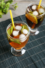 Glasses of tasty Cuba Libre cocktail on table