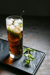 Glass of tasty Cuba Libre cocktail on table