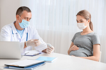 Pregnant diabetic woman visiting doctor in clinic