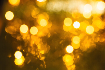 Bokeh texture from the light of Christmas lights yellow side on a gold background