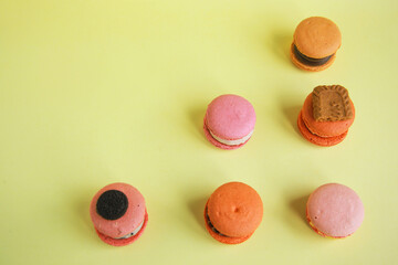 Top view of assortment colorful  korean macaroons on yellow background