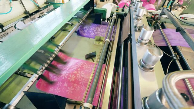 Plastic bag cutting machine at a polyethylene production factory
