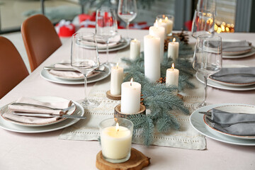Beautiful table setting with Christmas decorations in living room