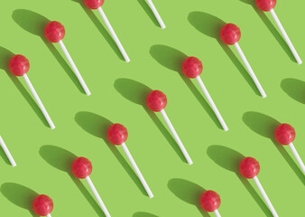 geometric pattern with chupachups on a green background. bright pattern. fun and sweets