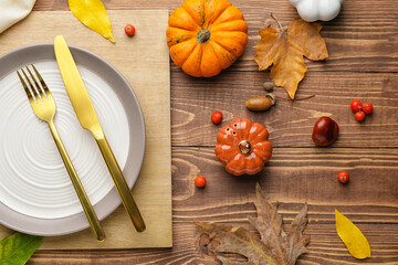 Beautiful table setting with autumn decor on wooden background