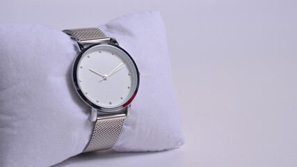 Women's watch on the watch pillow.