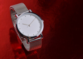 Women's watch on a red background.