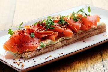 Pink salmon on pita bread with herbs