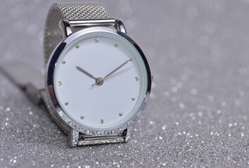 Women's watch on a silver background.
