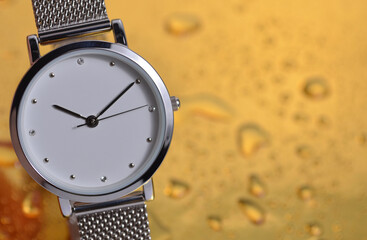 Close-up watch on a golden background. 