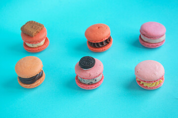 assortment colorful korean macaroons on bright blue background
