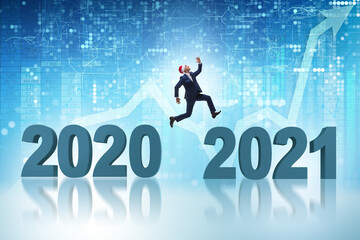 Businessman jumping from the year 2020 to 2021