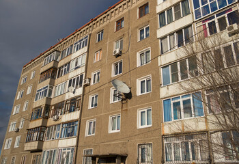 Fototapeta na wymiar Soviet apartment building. Apartment block. Soviet architecture. Ust-Kamenogorsk (Kazakhstan). Concrete apartment building. Plattenbau