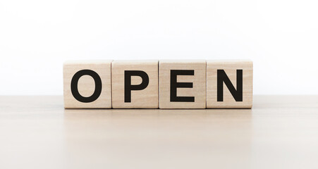 Word open on wooden blocks on a light background.