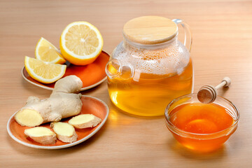 Ginger root tea with lemon and honey on the table.