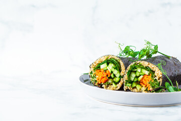 Vegetarian nori wraps with vegetables and quinoa, copy space. Healthy vegan food concept.