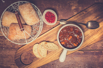 Polish breton beans with bacon, smoked sausages and onion, famous polish dish fasolka po bretonsku, baked beans in tomato sauce. A perfect dish for cold autumn days