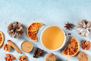 Winter background with Christmas tea and festive snacks, overhead shot with copy space, sustainable holidays concept