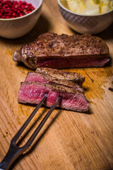 Beef steak on wooden table