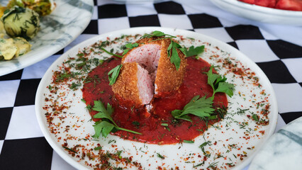 Seafood ball served with sauce and parsley