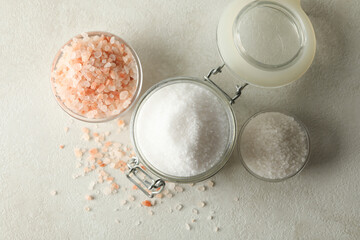 Bowls and jar with salt on white - gray table