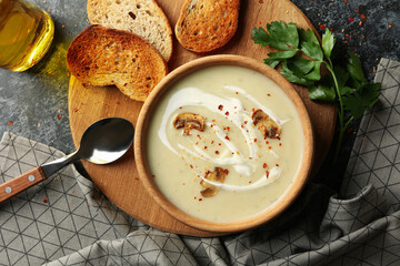 Concept of tasty lunch with bowl of mushroom soup on black smoky background