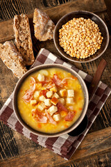 Traditional fresh pea soup in the bowl, top view
