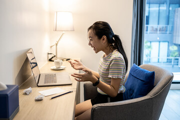 Surprised asian student getting exam results,pass exams looking excited,happy teen schoolgirl read good news while sit at work earning extra income on laptop computer,successful in making money online