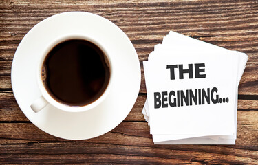 Business THE BEGINNING . White stickers with text on the wooden background with coffee