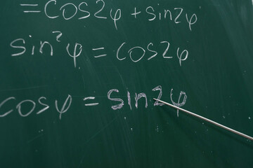 Mathematical formulas are written on the blackboard