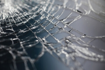 Crack on the glass. Broken screen. Broken phone. Cracked glass background. White cracks in the glass.