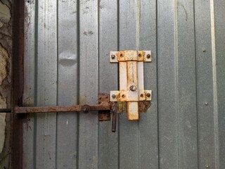 metal and rusty latch lock on a metal fence