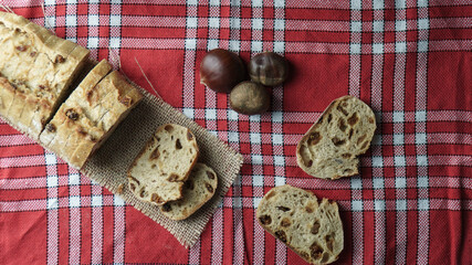 French figs bread on a white and red cloth with chestnuts on the side