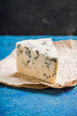 Tasty blue cheese on the rustic background. Selective focus. Shallow depth of field.