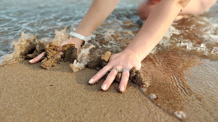 handprint on the sand by the sea