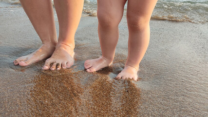 feet of child in the sea waves
