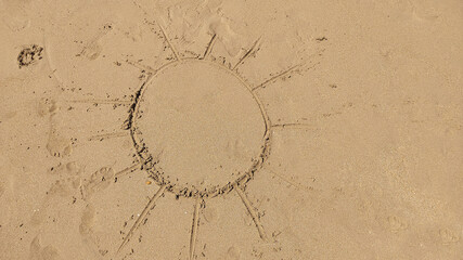 The symbol of the sun drawing on the sand
