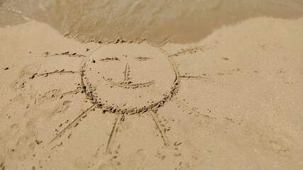 The symbol of the sun drawing on the sand