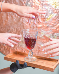 Many hands holding wine glass inside. Eating out in restaurant concept. Creative idea.