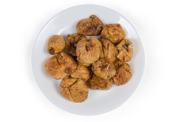Top view of dried figs on dish on white background