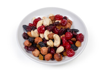 Mix of different nuts and dried fruits on white saucer